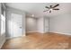 A large bedroom with light hardwood floors and neutral walls at 14119 Shelburne Village Dr, Charlotte, NC 28278