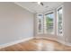 Bright, empty bedroom with bay window, hardwood floors, neutral walls, and white trim at 14119 Shelburne Village Dr, Charlotte, NC 28278