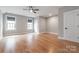 An open, bright room featuring hardwood floors and a ceiling fan at 14119 Shelburne Village Dr, Charlotte, NC 28278