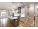 Gourmet kitchen boasts stainless steel appliances, a large island with sink, and custom cabinetry at 14119 Shelburne Village Dr, Charlotte, NC 28278
