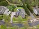 Stunning aerial view of a neighborhood featuring a home with mature trees, lush landscaping, inground pool and a three car garage at 1515 Millbridge Pkwy, Waxhaw, NC 28173
