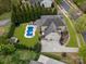 Aerial view of a home featuring a pool, three car garage, spacious yard and mature landscaping at 1515 Millbridge Pkwy, Waxhaw, NC 28173