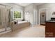 Relaxing bathroom featuring a soaking tub, glass shower, and tiled floor at 1515 Millbridge Pkwy, Waxhaw, NC 28173