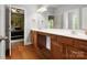 Bathroom features hardwood floors, double sinks, and dark wood cabinets at 1515 Millbridge Pkwy, Waxhaw, NC 28173