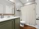 Bathroom features a toilet, a shower with a curtain, and olive-green cabinetry at 1515 Millbridge Pkwy, Waxhaw, NC 28173