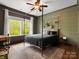Charming bedroom featuring a canopy bed, stylish decor, and large windows with natural light at 1515 Millbridge Pkwy, Waxhaw, NC 28173
