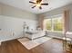 Bedroom with hardwood floors and a large window with curtains to provide natural light at 1515 Millbridge Pkwy, Waxhaw, NC 28173