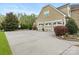 Spacious three-car garage with decorative doors, ample driveway space, and manicured landscaping adding curb appeal at 1515 Millbridge Pkwy, Waxhaw, NC 28173