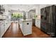 Modern kitchen with white cabinets, granite countertops, stainless appliances, and island at 1515 Millbridge Pkwy, Waxhaw, NC 28173