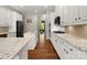 Spacious kitchen with white cabinets, hardwood floors, and granite countertops, creating an inviting cooking space at 1515 Millbridge Pkwy, Waxhaw, NC 28173