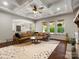 Open-concept living room featuring hardwood floors, coffered ceiling, and bright light from large windows at 1515 Millbridge Pkwy, Waxhaw, NC 28173