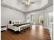 Spacious primary bedroom with tray ceilings, hardwood floors, and adjoining sitting area at 1515 Millbridge Pkwy, Waxhaw, NC 28173