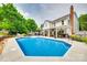 Spacious backyard with a large pool, patio, pergola, lush landscaping, and mature trees at 15306 Gower Ct, Charlotte, NC 28278