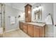 Bathroom with double sink vanity, granite countertops, and abundant cabinet space at 15306 Gower Ct, Charlotte, NC 28278