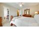 Cozy bedroom featuring a comfortable bed, wood furnishings, and a glimpse into the walk-in closet at 15306 Gower Ct, Charlotte, NC 28278