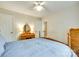 Bright bedroom with a comfortable bed, warm walls, ceiling fan, and traditional furnishings at 15306 Gower Ct, Charlotte, NC 28278