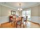 Dining room featuring hardwood floors, chandelier, natural light, and neutral paint at 15306 Gower Ct, Charlotte, NC 28278