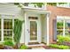 Close up of front door with glass and storm door, brick and white siding at 15306 Gower Ct, Charlotte, NC 28278