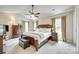 Spacious main bedroom featuring a ceiling fan, plush carpet, and natural light at 15306 Gower Ct, Charlotte, NC 28278