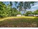 Expansive backyard featuring lush greenery, mature trees, and versatile storage structures at 1774 Wintertide Rd, Jefferson, SC 29718