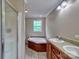 Bathroom with double vanity, large soaking tub, and separate shower, creating a spa-like experience at 1774 Wintertide Rd, Jefferson, SC 29718