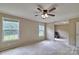 Spacious bedroom featuring two bright windows, a ceiling fan, and neutral carpeting for a comfortable retreat at 1774 Wintertide Rd, Jefferson, SC 29718