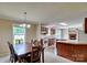 Dining area with a wood table, classic chandelier, and seamless flow into the kitchen and living space at 1774 Wintertide Rd, Jefferson, SC 29718