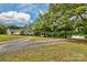 Charming single story home with a long gravel driveway, mature trees, and a detached carport at 1774 Wintertide Rd, Jefferson, SC 29718
