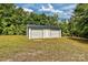 Two-car detached garage with white doors and siding, providing ample storage and parking at 1774 Wintertide Rd, Jefferson, SC 29718