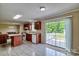 Bright kitchen with sliding doors to deck and view to dining area at 1774 Wintertide Rd, Jefferson, SC 29718