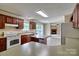 Open-concept kitchen featuring an island, tile flooring, and seamlessly connecting to the living room with a fireplace at 1774 Wintertide Rd, Jefferson, SC 29718
