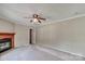 Comfortable living room features a cozy fireplace and ceiling fan for year-round comfort at 1774 Wintertide Rd, Jefferson, SC 29718