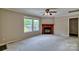 Cozy living room featuring a classic fireplace with wood mantel and abundant natural light at 1774 Wintertide Rd, Jefferson, SC 29718