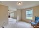 Neutral living room with a window offering natural light and an open space to another room at 1774 Wintertide Rd, Jefferson, SC 29718