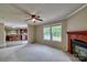 Open living room with fireplace and large windows, seamlessly connected to the kitchen at 1774 Wintertide Rd, Jefferson, SC 29718