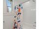 Bright bathroom with white subway tile, bathtub, floral shower curtain, and a window at 1933 Thurmond Pl, Charlotte, NC 28205