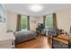 Bedroom features a full bed, hardwood floors, media center, and a comfortable workspace at 1933 Thurmond Pl, Charlotte, NC 28205