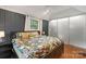 Comfortable bedroom with dark blue paneled walls, hardwood floors and closet at 1933 Thurmond Pl, Charlotte, NC 28205