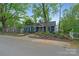 Landscaped front yard and blue exterior showcase this charming home's curb appeal at 1933 Thurmond Pl, Charlotte, NC 28205