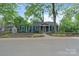 Landscaped front yard and blue exterior showcase this charming home's curb appeal at 1933 Thurmond Pl, Charlotte, NC 28205
