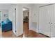 Hallway with hardwood floors leading to a living area with blue couch at 1933 Thurmond Pl, Charlotte, NC 28205