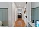 Hallway with hardwood floors leading to a bedroom, doors and light gray walls at 1933 Thurmond Pl, Charlotte, NC 28205