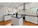 Stylish kitchen with stainless appliances, island, and white subway tile backsplash at 1933 Thurmond Pl, Charlotte, NC 28205