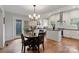 Eat-in kitchen features stainless appliances, white cabinets, and subway tile backsplash at 1933 Thurmond Pl, Charlotte, NC 28205