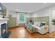 Bright living room with hardwood floors, fireplace, and stylish paneling at 1933 Thurmond Pl, Charlotte, NC 28205