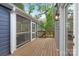 Enclosed porch showcasing a wooden deck, screening, and access to the home's exterior at 1933 Thurmond Pl, Charlotte, NC 28205