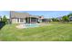 A beautifully designed backyard pool with an attached spa and a covered patio, perfect for relaxation at 1963 Felts Pkwy, Fort Mill, SC 29715