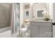Cozy bathroom with a shower and tub combination, decorative mirror and granite vanity at 1963 Felts Pkwy, Fort Mill, SC 29715