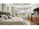A bright bedroom with a bay window overlooking the backyard, and dark-wood furniture at 1963 Felts Pkwy, Fort Mill, SC 29715