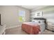 Cozy bedroom features striped accent wall, plush carpet, and bright window at 1963 Felts Pkwy, Fort Mill, SC 29715